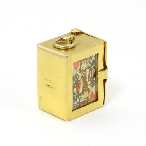 548 - A 9ct gold charm containing a miniature deck of cards 3/4