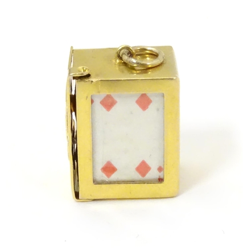 548 - A 9ct gold charm containing a miniature deck of cards 3/4