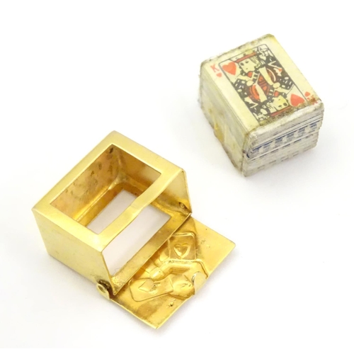 548 - A 9ct gold charm containing a miniature deck of cards 3/4