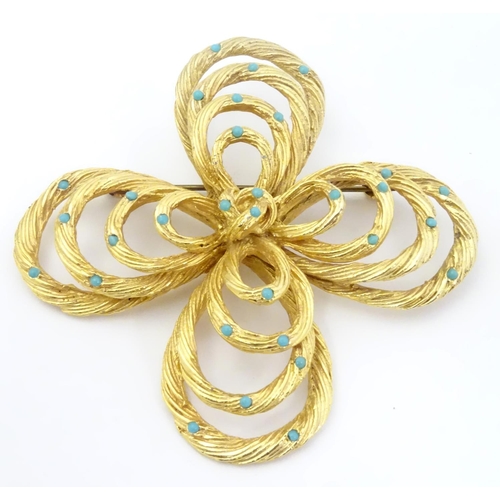 555 - Vintage costume jewellery : A large brooch set with faux turquoise detail marked A1648 to back. 2 3/... 