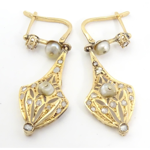 556 - A pair of gold drop earrings set with diamonds and pearls. Approx 1 1/2