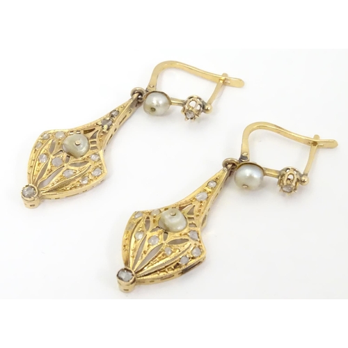 556 - A pair of gold drop earrings set with diamonds and pearls. Approx 1 1/2