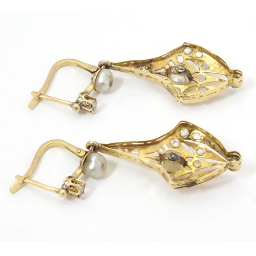 556 - A pair of gold drop earrings set with diamonds and pearls. Approx 1 1/2