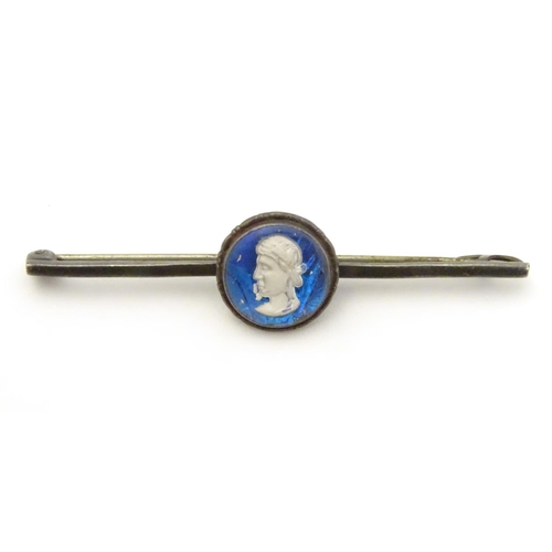 563 - A white metal bar brooch, stamped STERLING BERMUDA, the central circular section containing a white ... 