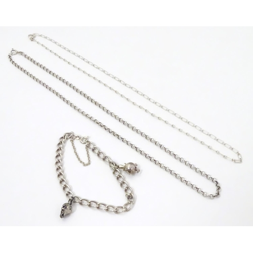 567 - Two silver chain necklaces together with a silver chain bracelet with two charms, one formed as a sk... 