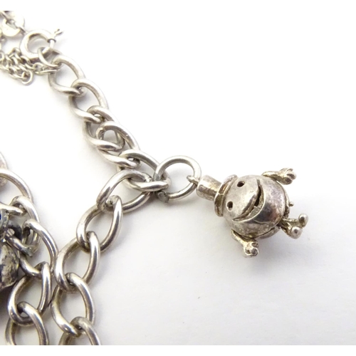 567 - Two silver chain necklaces together with a silver chain bracelet with two charms, one formed as a sk... 