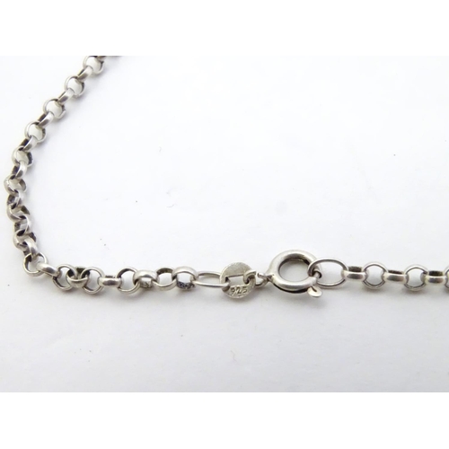 567 - Two silver chain necklaces together with a silver chain bracelet with two charms, one formed as a sk... 