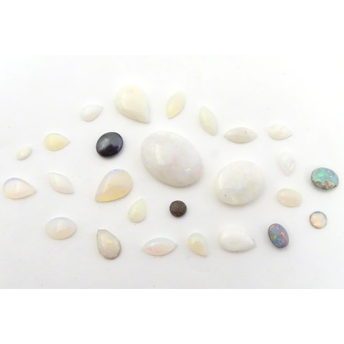 570 - A quantity of assorted unmounted opal and opalescent cabochon etc The largest approx 3/4