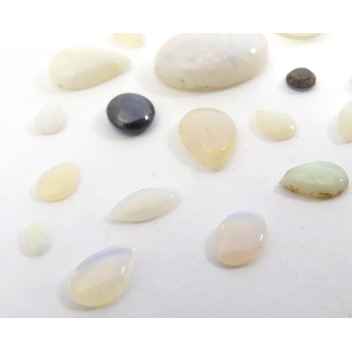 570 - A quantity of assorted unmounted opal and opalescent cabochon etc The largest approx 3/4