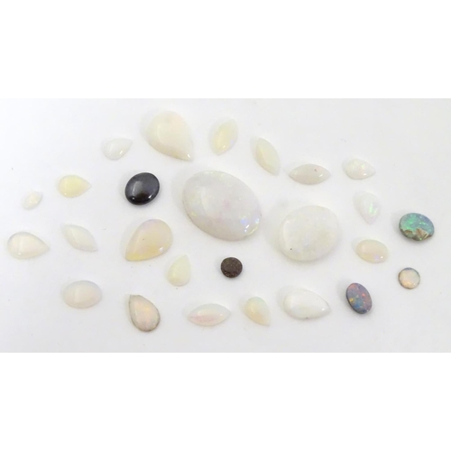 570 - A quantity of assorted unmounted opal and opalescent cabochon etc The largest approx 3/4