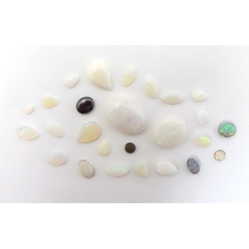 570 - A quantity of assorted unmounted opal and opalescent cabochon etc The largest approx 3/4