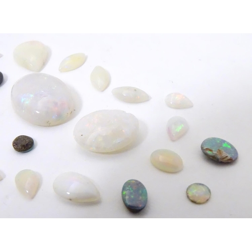 570 - A quantity of assorted unmounted opal and opalescent cabochon etc The largest approx 3/4