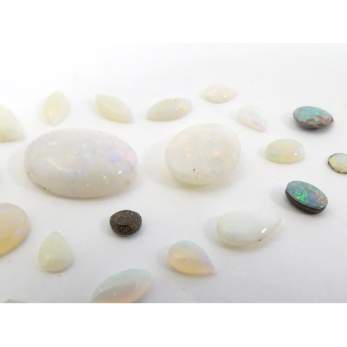 570 - A quantity of assorted unmounted opal and opalescent cabochon etc The largest approx 3/4