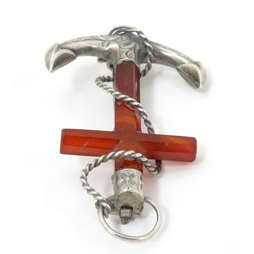 572 - A Victorian brooch formed as an anchor set with carnelian and white metal detail. 3