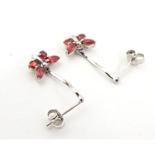 583 - 9ct white gold drop earrings with butterfly detail red stones. 3/4