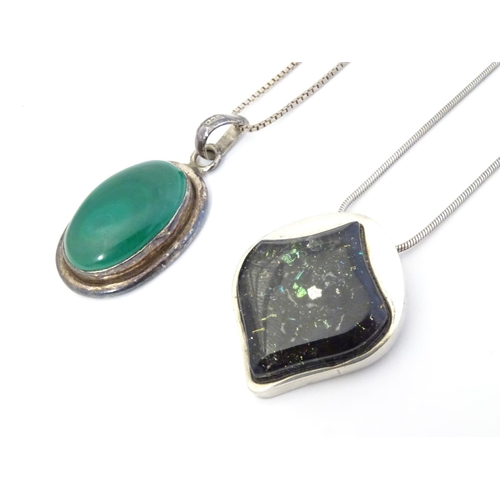 586 - A silver pedant and chain the pendant set with malachite coloured cabochon. The pendant 1 3/4