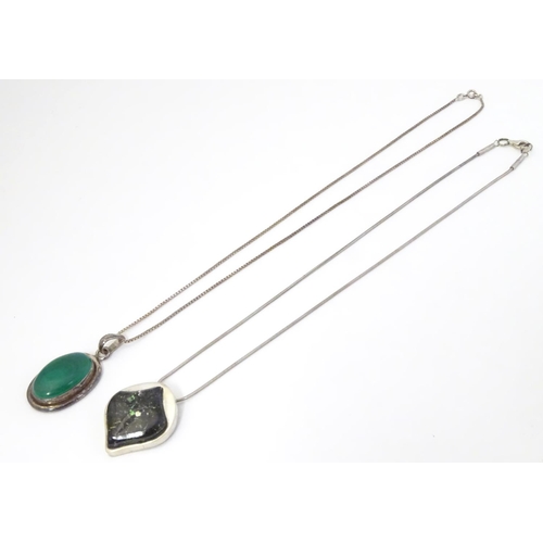 586 - A silver pedant and chain the pendant set with malachite coloured cabochon. The pendant 1 3/4