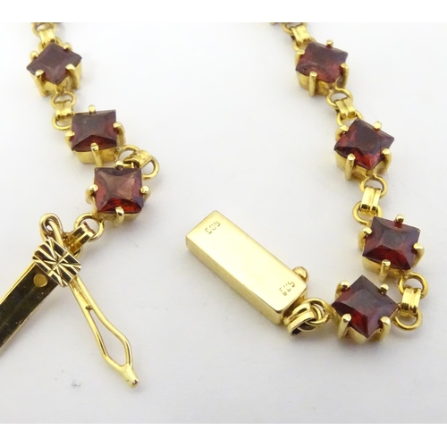 587 - A 14ct gold bracelet set with 14 garnets together with matching stud earrings