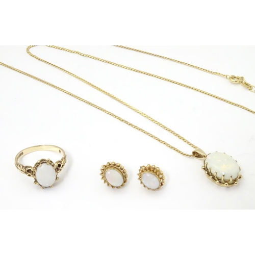 588 - A 9ct gold opal jewellery comprising necklace earrings and rings set with opal cabochon.