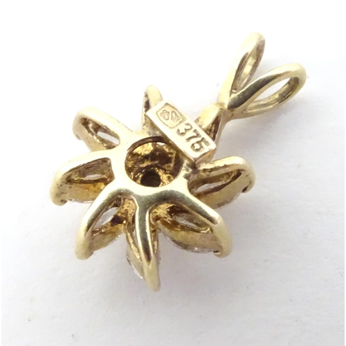 591 - A 9ct gold pendant of flower form set with white stones. 3/4