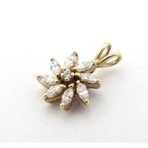 591 - A 9ct gold pendant of flower form set with white stones. 3/4