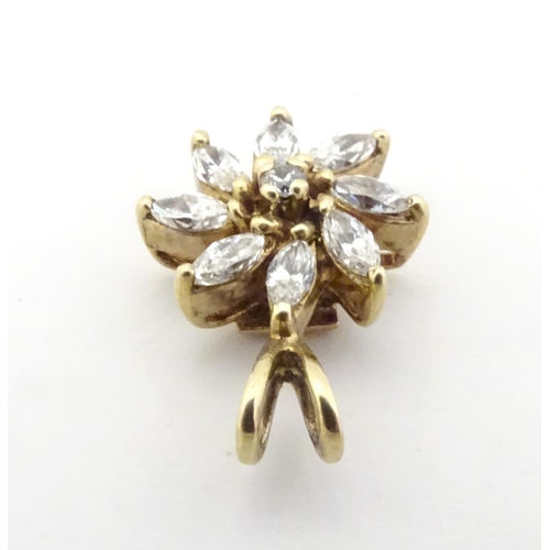 591 - A 9ct gold pendant of flower form set with white stones. 3/4