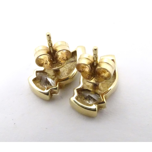 592 - A pair of 9ct gold stud earrings set with white stones