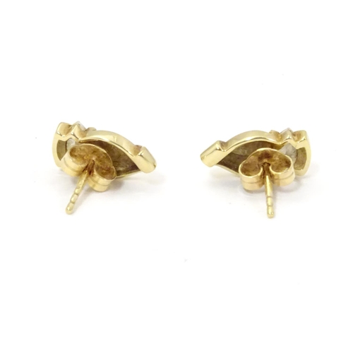 592 - A pair of 9ct gold stud earrings set with white stones