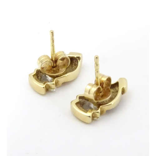 592 - A pair of 9ct gold stud earrings set with white stones