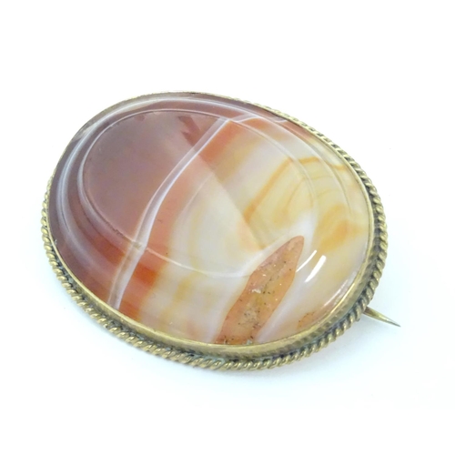 595 - A late 19thC / early 20thC brooch set with agate hardstone in a gilt metal mount. 1 3/4