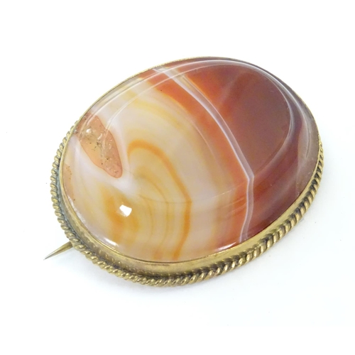 595 - A late 19thC / early 20thC brooch set with agate hardstone in a gilt metal mount. 1 3/4