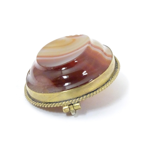 595 - A late 19thC / early 20thC brooch set with agate hardstone in a gilt metal mount. 1 3/4