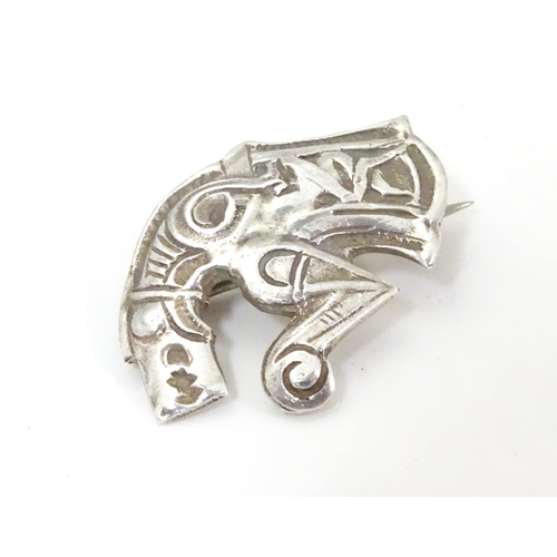 597 - An unusual silver brooch formed as a mythical dragon / horse creature. Possibly Scandinavian 1 1/4