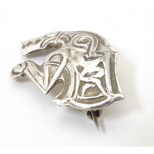 597 - An unusual silver brooch formed as a mythical dragon / horse creature. Possibly Scandinavian 1 1/4