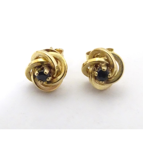 600 - A pair of 9ct gold stud earrings set with blue stones 1/ 4