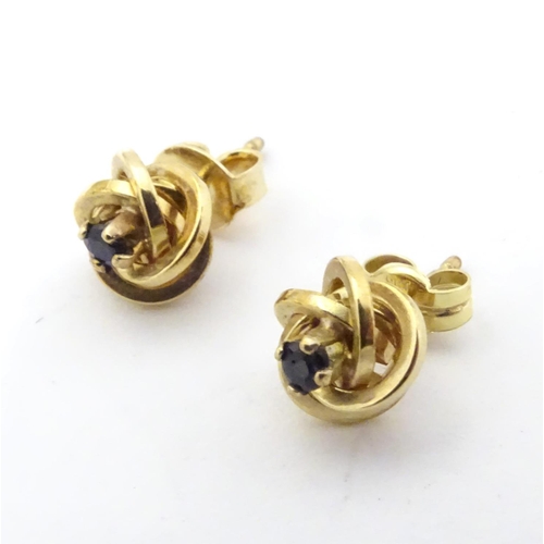 600 - A pair of 9ct gold stud earrings set with blue stones 1/ 4