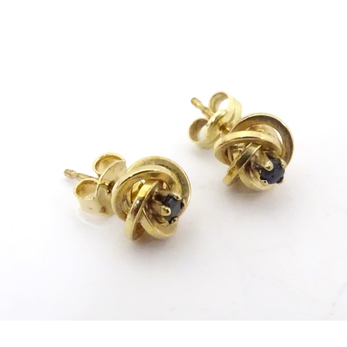 600 - A pair of 9ct gold stud earrings set with blue stones 1/ 4