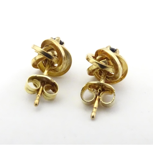 600 - A pair of 9ct gold stud earrings set with blue stones 1/ 4