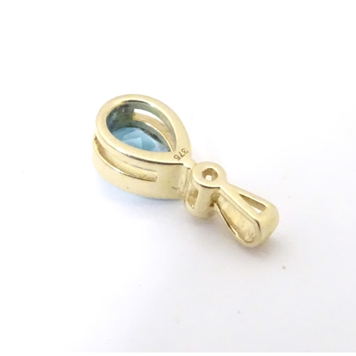 610 - A 9ct gold pendant set with blue topaz 1/2