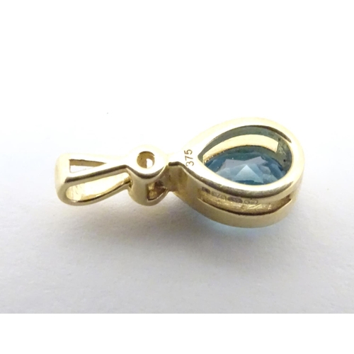 610 - A 9ct gold pendant set with blue topaz 1/2