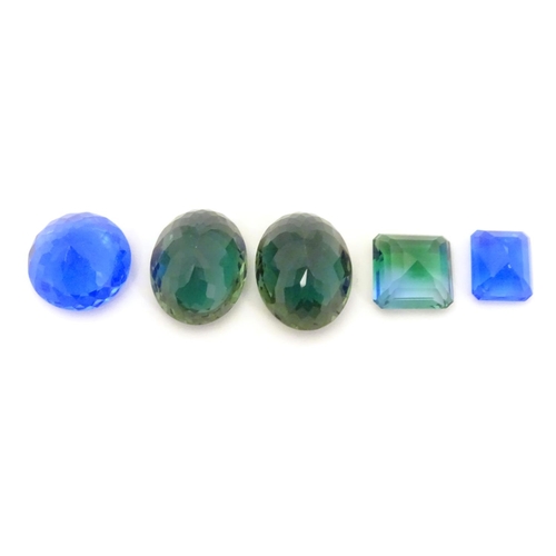 612 - 5 assorted blue / green stones. Unmounted. The largest approx  1