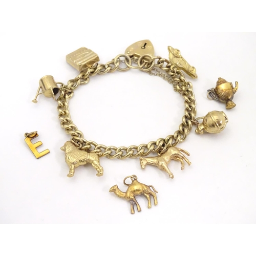 617 - A 9ct gold charm bracelet set with various 9ct gold charms