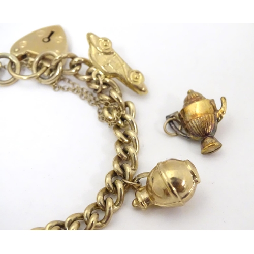 617 - A 9ct gold charm bracelet set with various 9ct gold charms