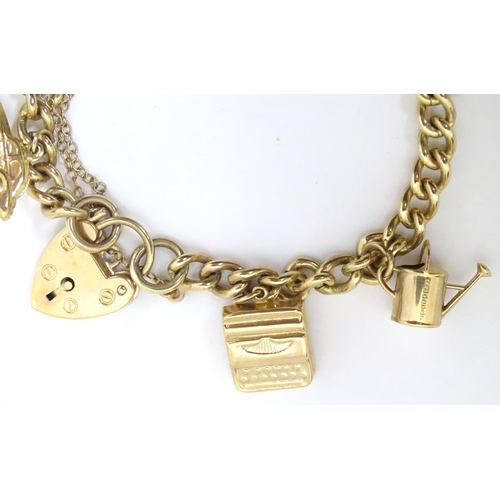 617 - A 9ct gold charm bracelet set with various 9ct gold charms