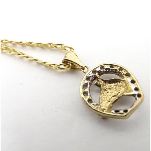 618 - A 9ct gold pendant formed as a horseshoe with horsehead detail set with diamonds, on a 9ct gold chai... 