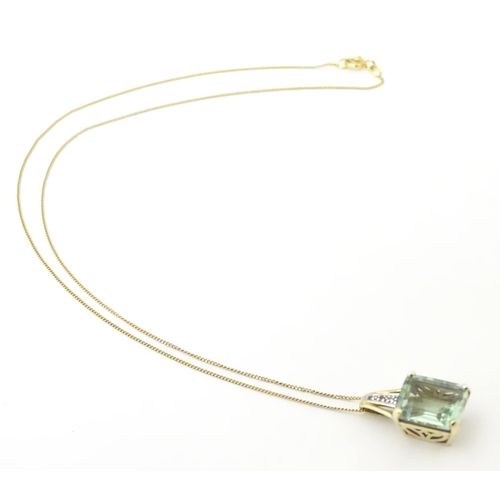 625 - A 9ct gold pendant set with pale green spinel and diamonds on a 16