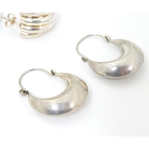 627 - Four assorted pairs of silver and white metal earrings.