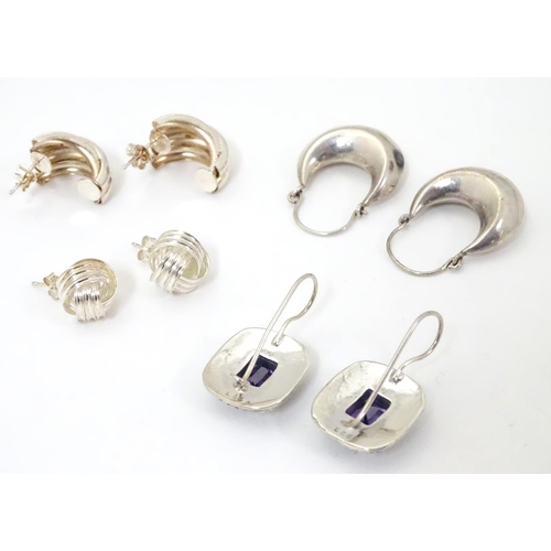 627 - Four assorted pairs of silver and white metal earrings.