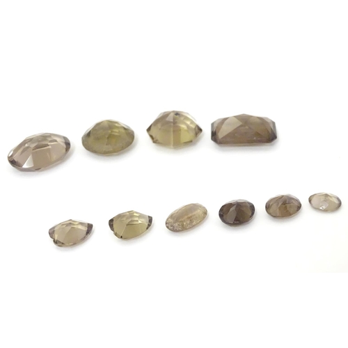 628 - Assorted facet cut smoky quartz stones. unmounted.  The largest approx 1