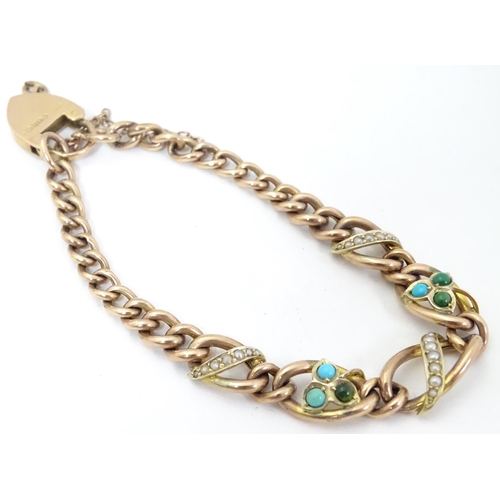 629 - A 9ct gold bracelet set with seed pearl and turquoise in a shamrock setting